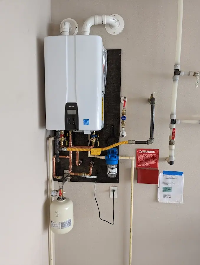 Professional plumber installing copper piping in a Cornwall home